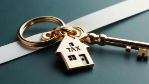 Keyring with key, house and tax written on it
